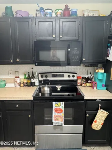 a kitchen with stainless steel appliances granite countertop a stove and cabinets