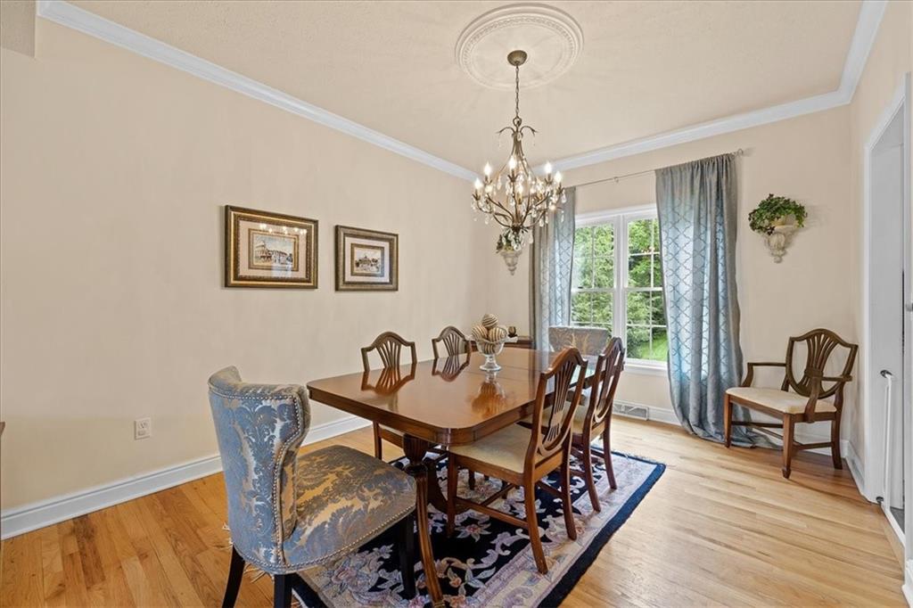 507 Sandra Lane Cheswick, PA 15024 - Photo 15 of 24 a dining room with furniture a chandelier and wooden floor