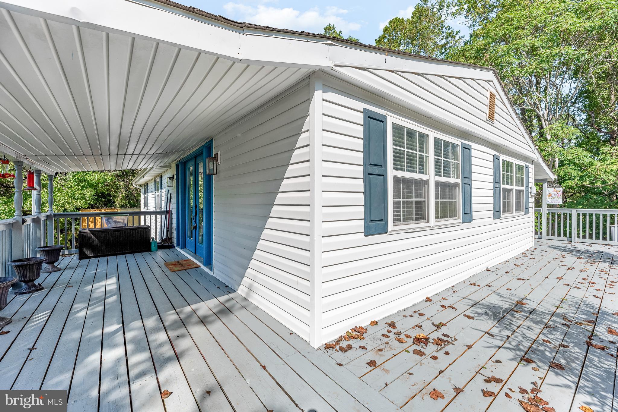 9235 Pardoe Road Lusby, MD 20657 - Photo 4 of 28 Lovely deck wraps around half of the home.