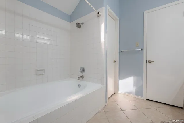 a bathroom with a bathtub and shower