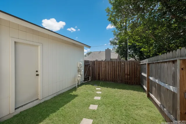 a view of a backyard with a tree