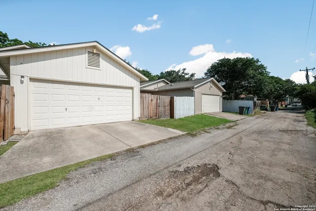 a view of a house with a yard and garage