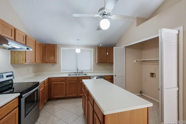 a kitchen that has a sink stainless steel appliances a counter space and cabinets