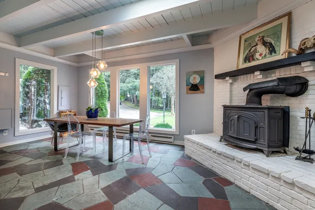 a living room with furniture a window and a fireplace