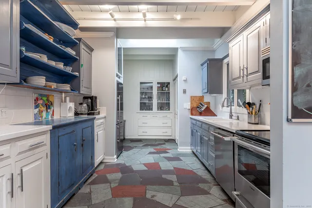 a kitchen with stainless steel appliances granite countertop a stove and cabinets