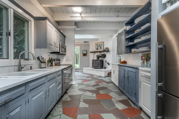a kitchen with refrigerator and cabinets