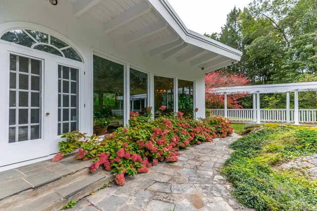 a view of a house with a flower garden