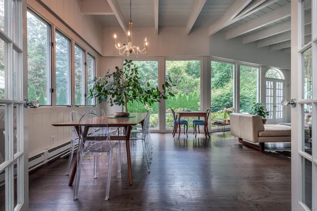 a view of a dining room with furniture and a large window