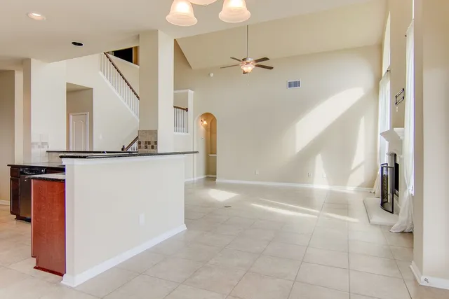 a view of a livingroom with wooden floor and stairs