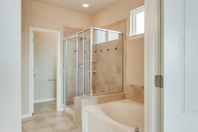 a bathroom with a shower and a tub
