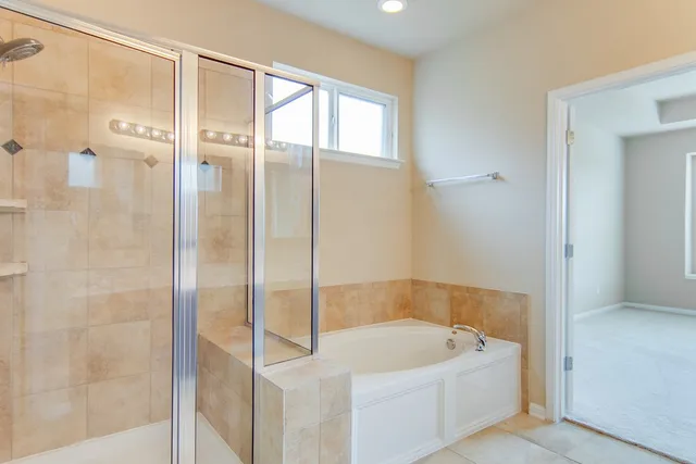 a bath tub sitting next to a shower
