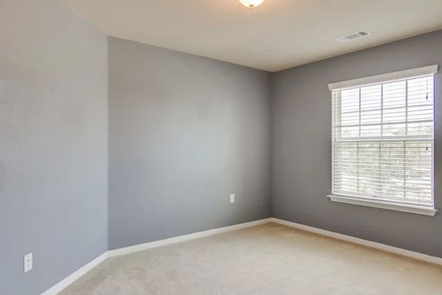 an empty room with windows and with windows