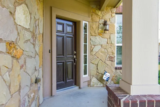 a living room with a table and a chandelier