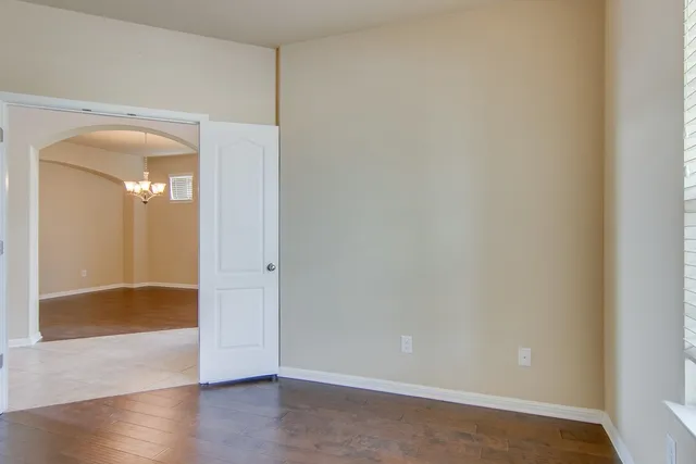a view of a small space with wooden floor and a sink