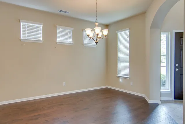 a view of wooden floor and windows in a room