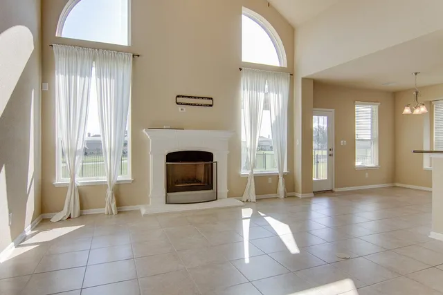 a view of a livingroom with an empty space and a fireplace