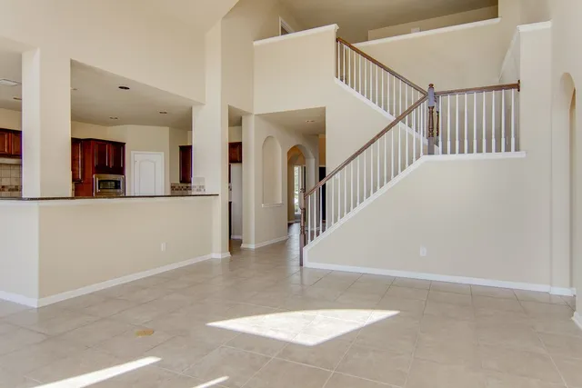 a view of a livingroom with wooden floor and stairs