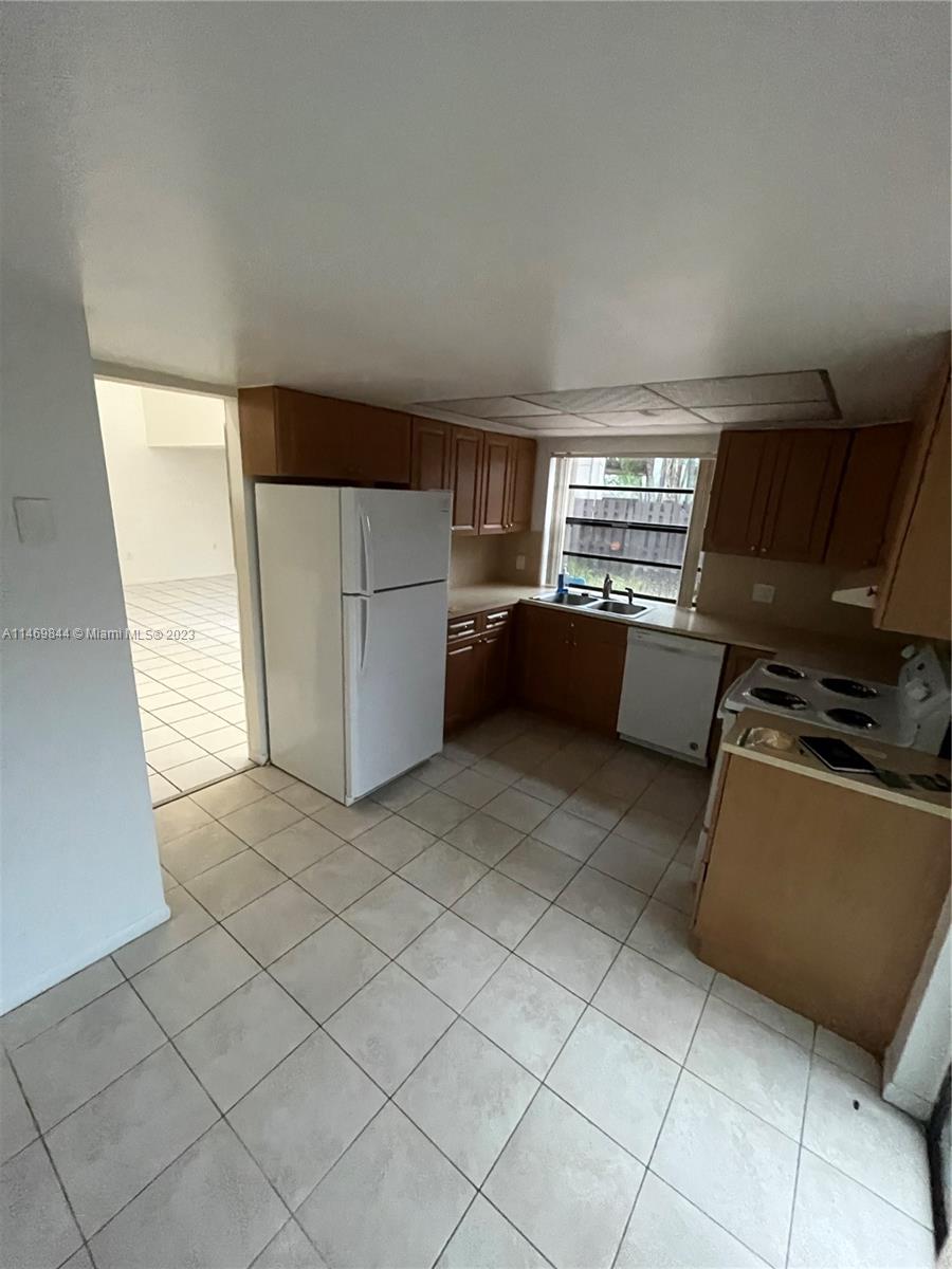The Crossings Miami, FL 33186 - Photo 13 of 14 a kitchen with a refrigerator and a stove top oven