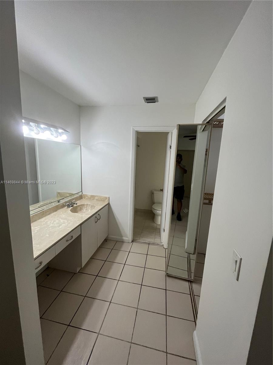 The Crossings Miami, FL 33186 - Photo 4 of 14 a bathroom with a sink and mirror with bathtub