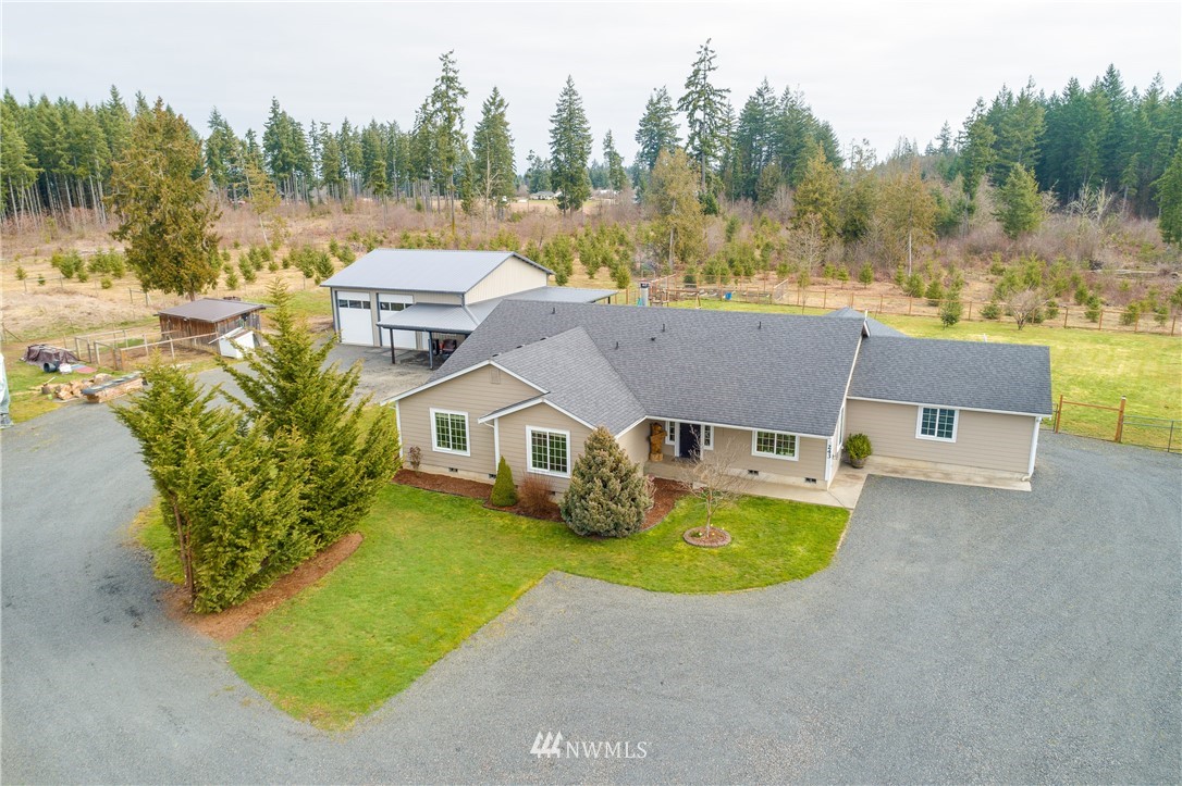 243 Gartner Road Winlock, WA 98596 - Photo 2 of 38 an aerial view of a house with a big yard and large trees
