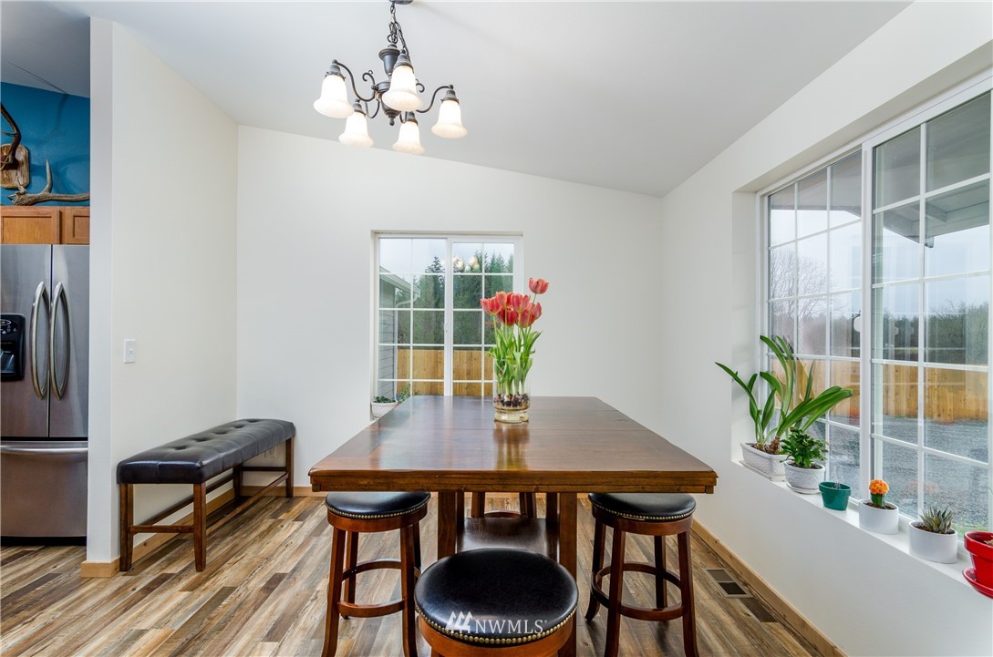 243 Gartner Road Winlock, WA 98596 - Photo 11 of 38 a view of a dining room with furniture and a potted plant