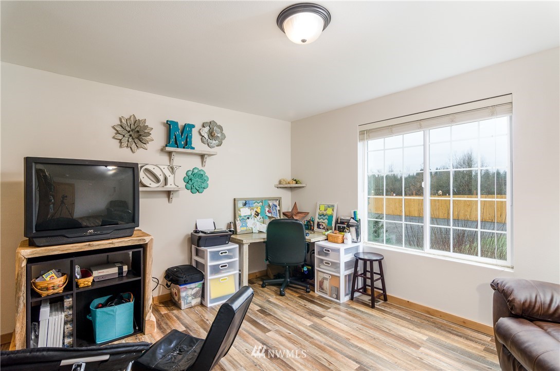 243 Gartner Road Winlock, WA 98596 - Photo 17 of 38 a living room with furniture a flat screen tv and a window