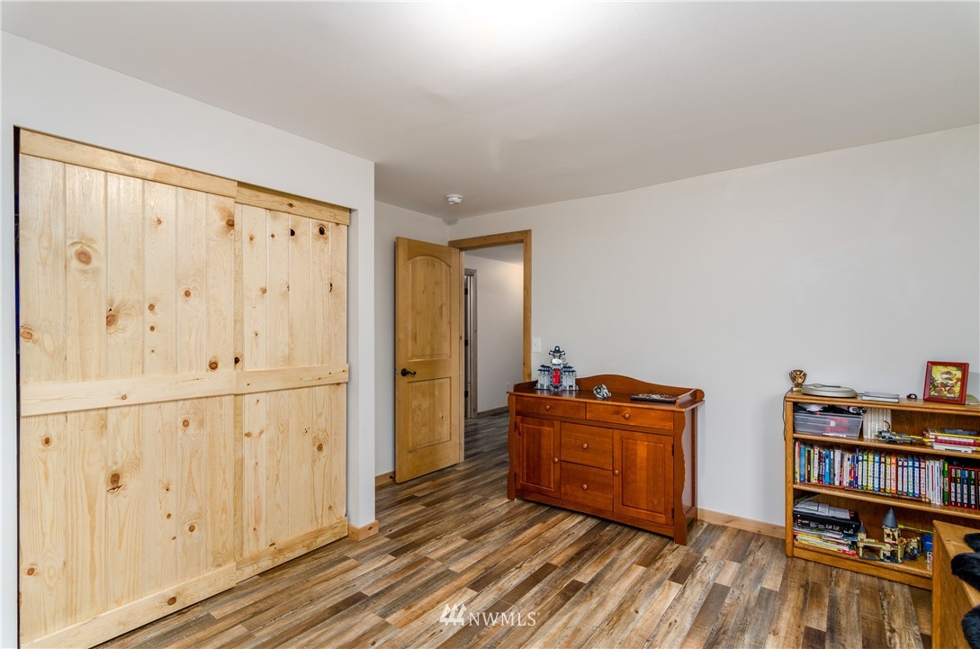 243 Gartner Road Winlock, WA 98596 - Photo 19 of 38 a living room with closet and gym equipment