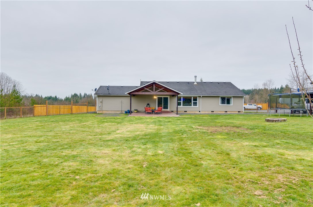243 Gartner Road Winlock, WA 98596 - Photo 26 of 38 a front view of a house with a yard table and chair