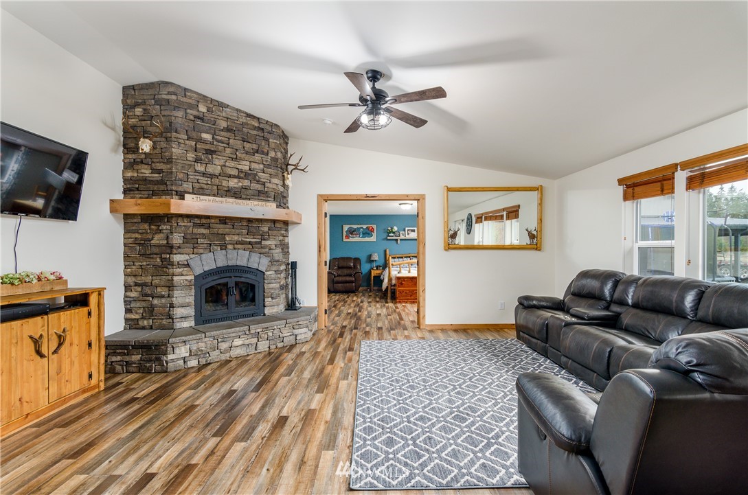 243 Gartner Road Winlock, WA 98596 - Photo 4 of 38 a living room with furniture a flat screen tv and a fireplace