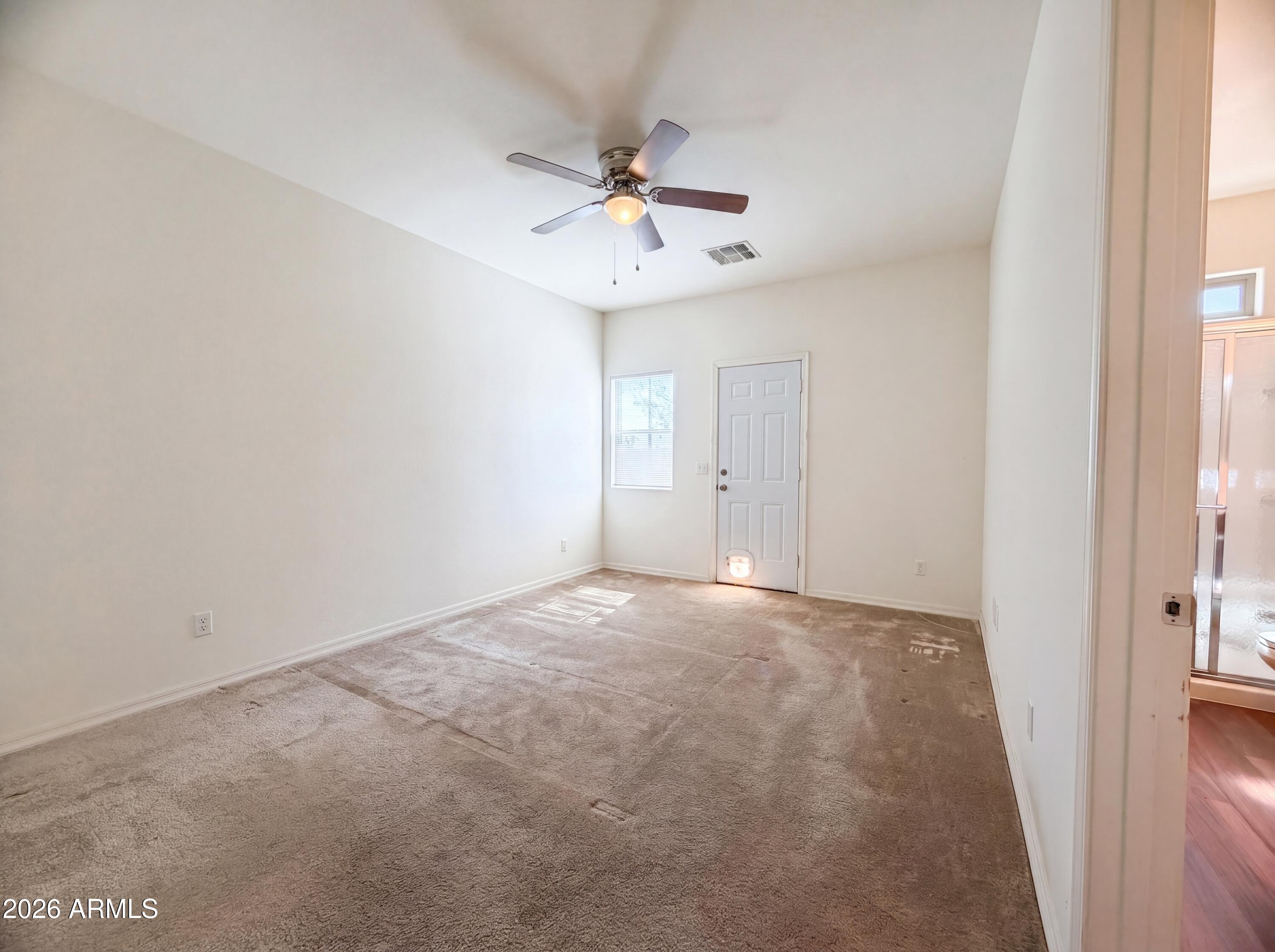 1738 South Aryelle Road Apache Junction, AZ 85119 - Photo 12 of 17 an empty room with a window and a ceiling fan
