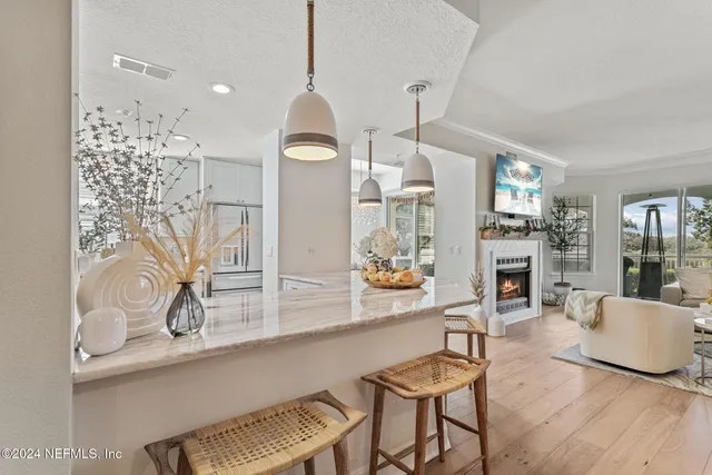 a kitchen with kitchen island granite countertop a sink cabinets and stainless steel appliances