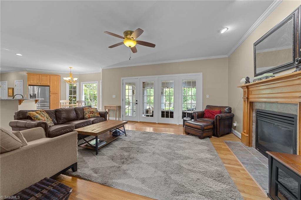5806 Billet Road Oak Ridge, NC 27310 - Photo 11 of 46 GREAT ROOM WITH GAS LOGS AND SCREENED PROCH BEYOND