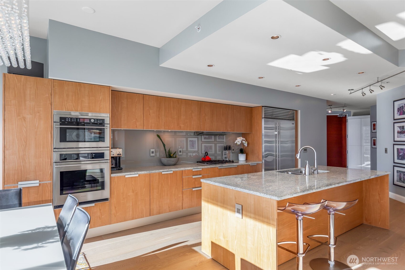 1920 4th Avenue, Unit 1405 Seattle, WA 98101 - Photo 11 of 40 a kitchen with stainless steel appliances kitchen island granite countertop a sink and a refrigerator