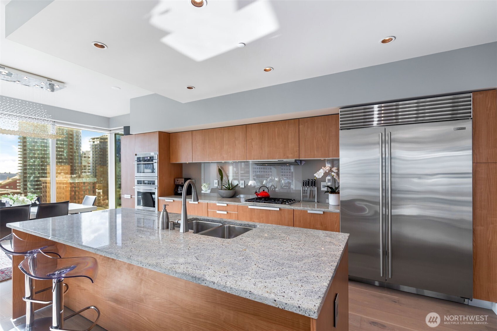 1920 4th Avenue, Unit 1405 Seattle, WA 98101 - Photo 12 of 40 a kitchen with stainless steel appliances granite countertop a sink refrigerator and cabinets