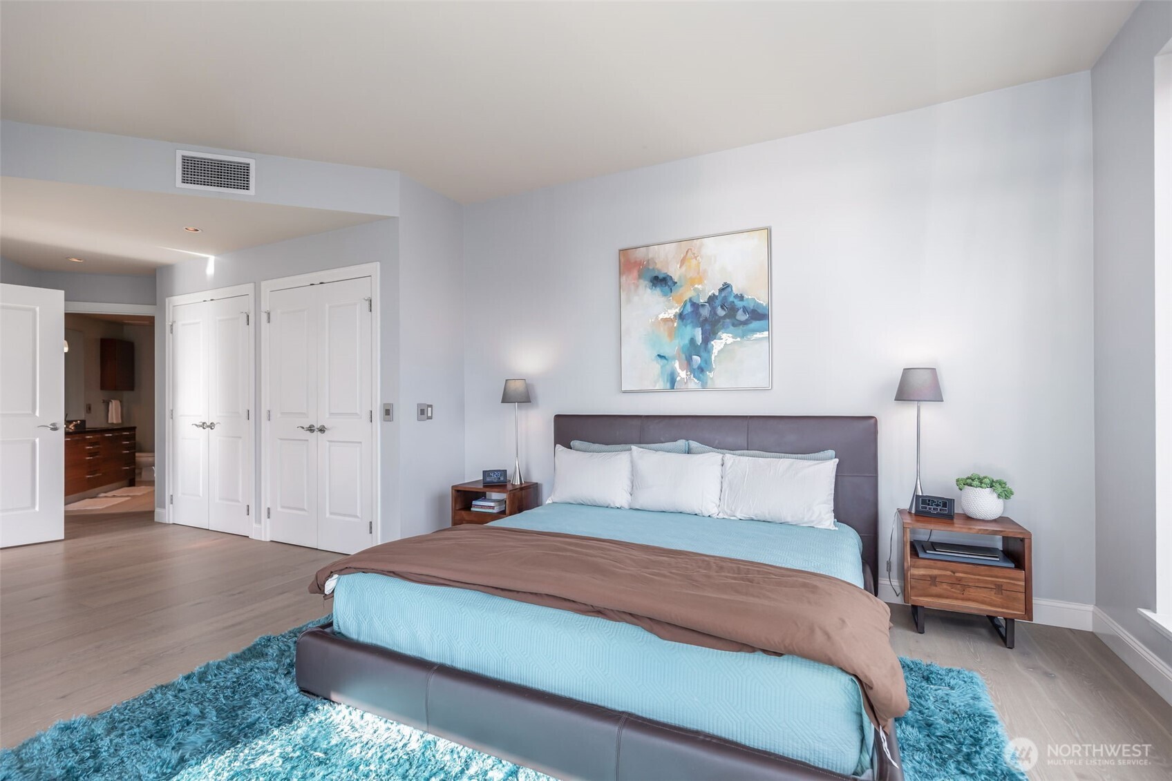 1920 4th Avenue, Unit 1405 Seattle, WA 98101 - Photo 17 of 40 a bedroom with a bed and a painting on the wall