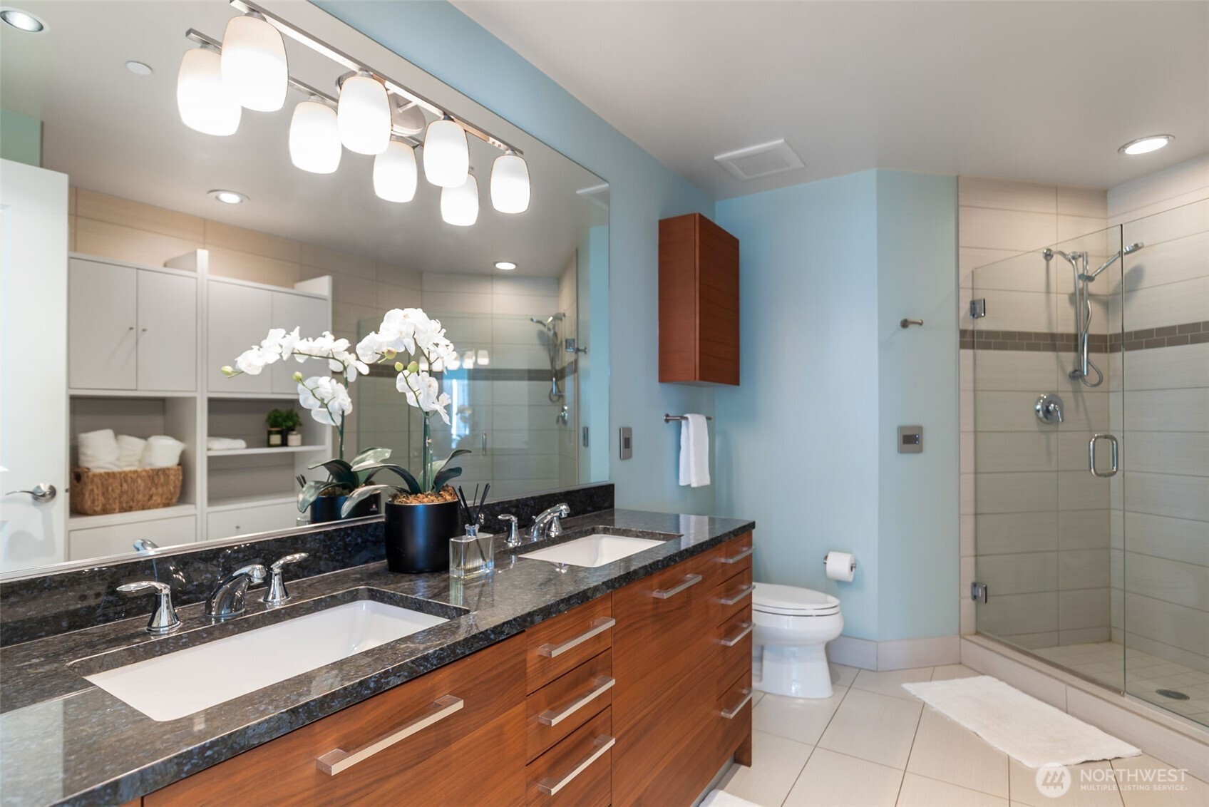 1920 4th Avenue, Unit 1405 Seattle, WA 98101 - Photo 18 of 40 a bathroom with a double vanity sink mirror and shower