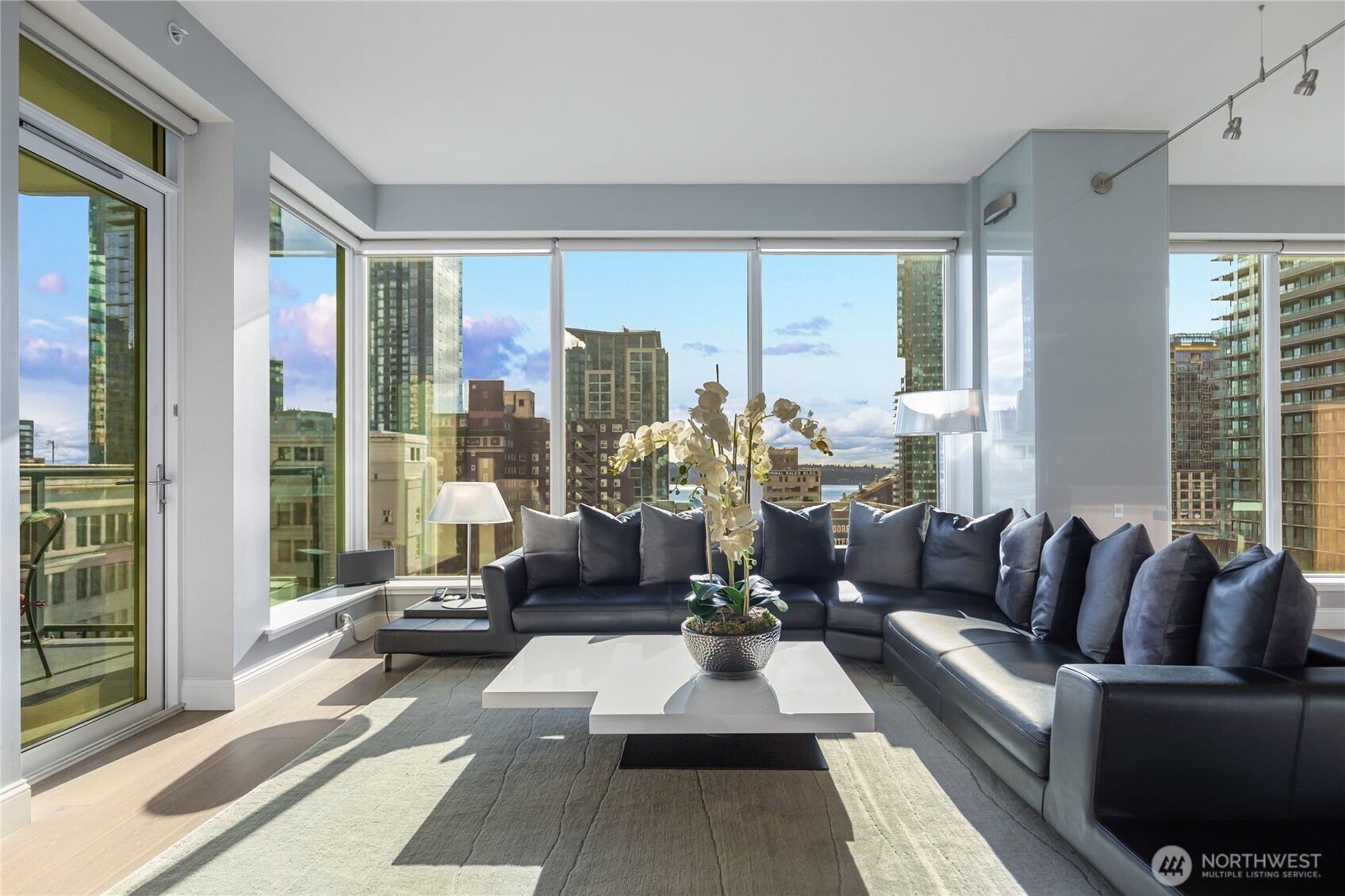 1920 4th Avenue, Unit 1405 Seattle, WA 98101 - Photo 22 of 40 a living room with furniture and large windows