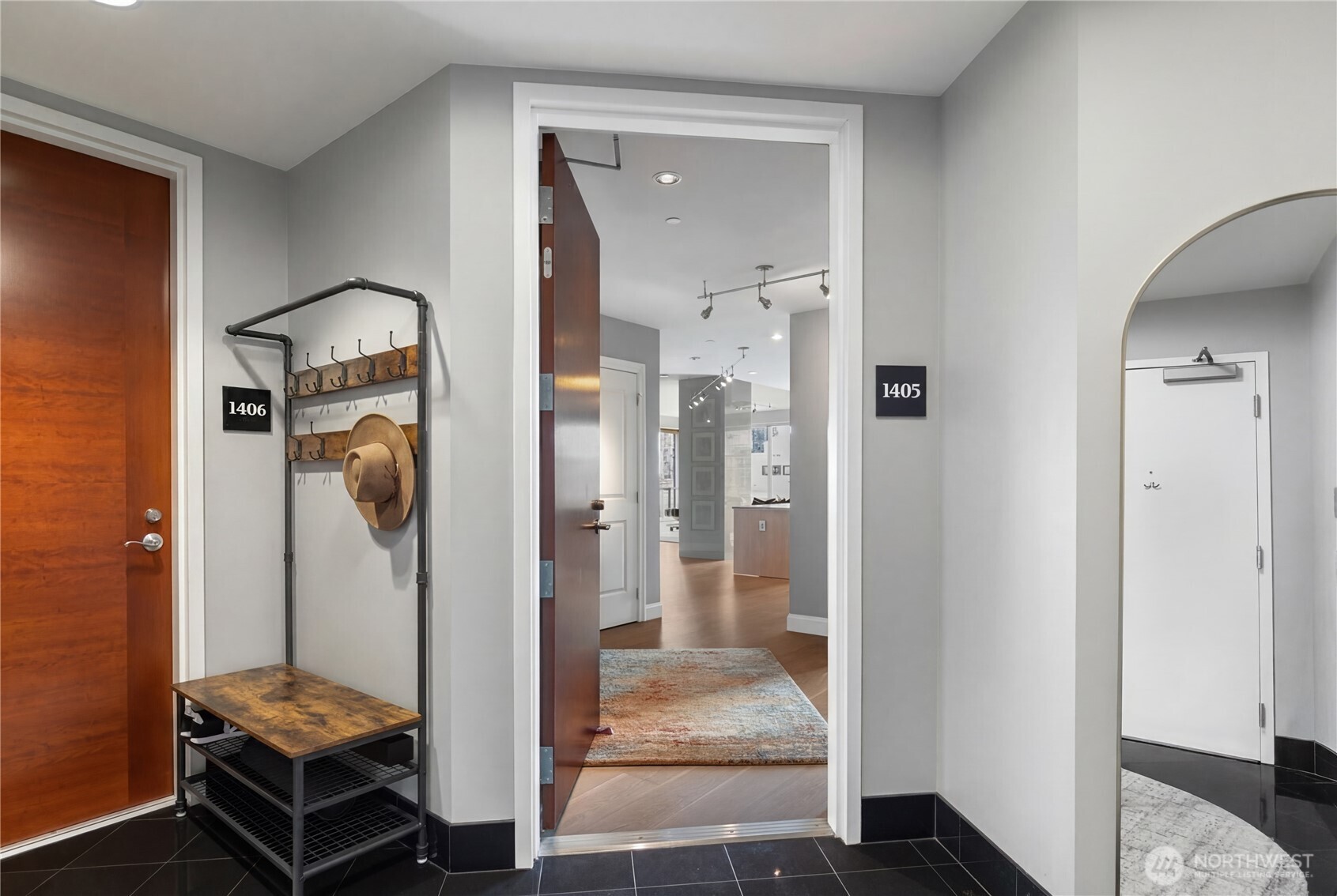 1920 4th Avenue, Unit 1405 Seattle, WA 98101 - Photo 29 of 40 a room that has a glass door and a hallway