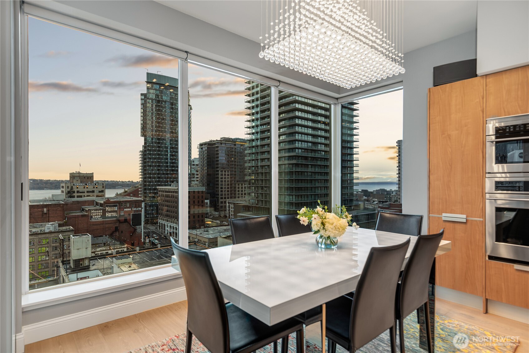 1920 4th Avenue, Unit 1405 Seattle, WA 98101 - Photo 4 of 40 a dining room with furniture and wooden floor