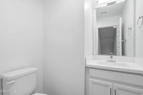 a bathroom with a sink a toilet and mirror