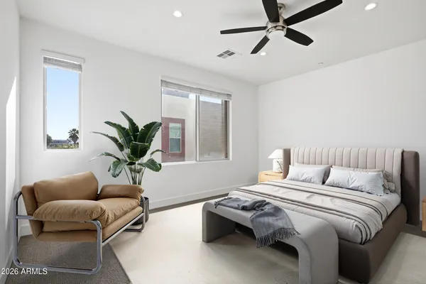 a bedroom with a bed couch and window