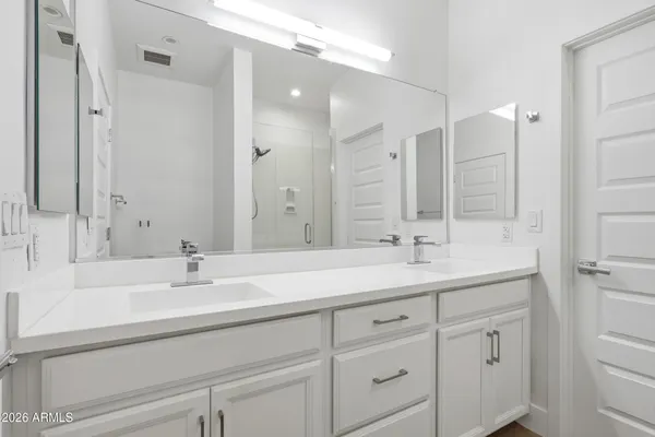 a bathroom with a sink double vanity and a mirror