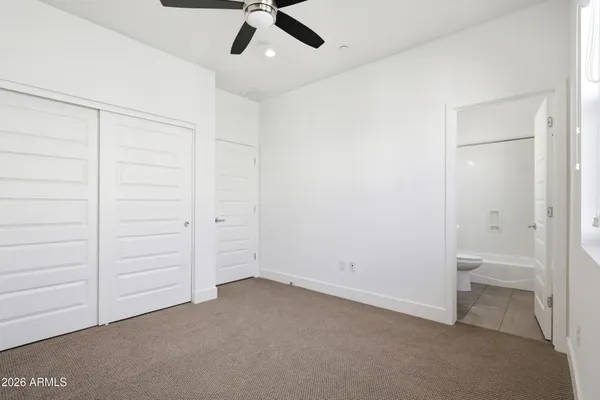 an empty room with a ceiling fan