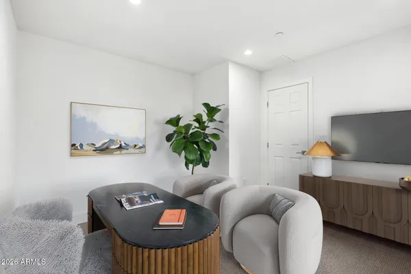a living room with furniture and a potted plant