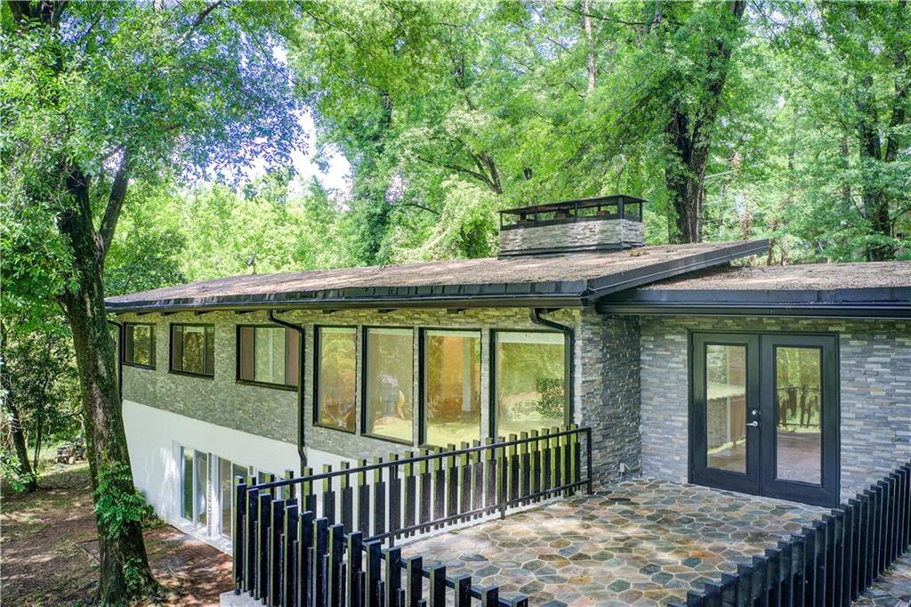 1676 Moores Mill Road Northwest Atlanta, GA 30327 - Photo 11 of 32 a view of a house with a balcony