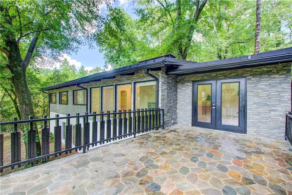 1676 Moores Mill Road Northwest Atlanta, GA 30327 - Photo 12 of 32 a view of a house with a large window