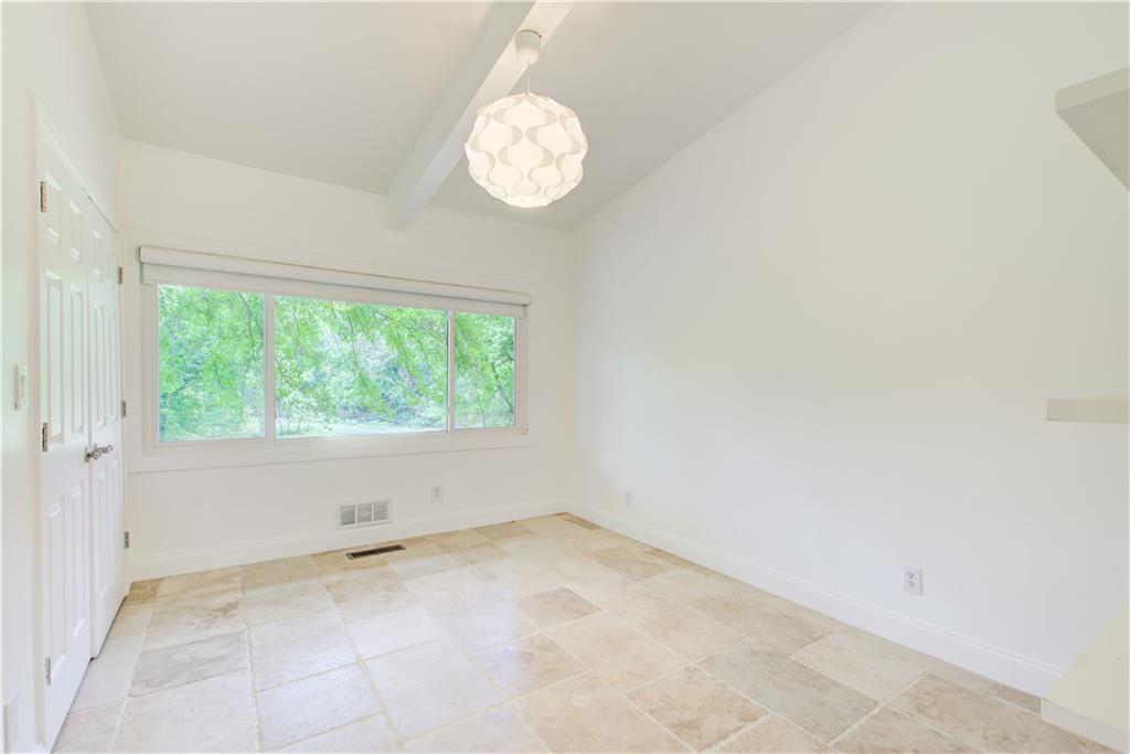1676 Moores Mill Road Northwest Atlanta, GA 30327 - Photo 15 of 32 an empty room with a window