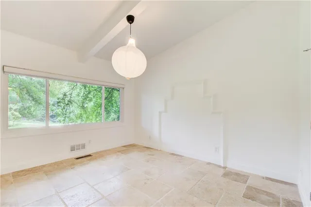 a view of a room with wooden floor and glass doors