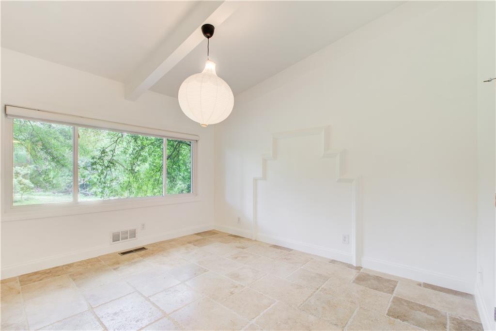 1676 Moores Mill Road Northwest Atlanta, GA 30327 - Photo 17 of 32 a view of an empty room with a window