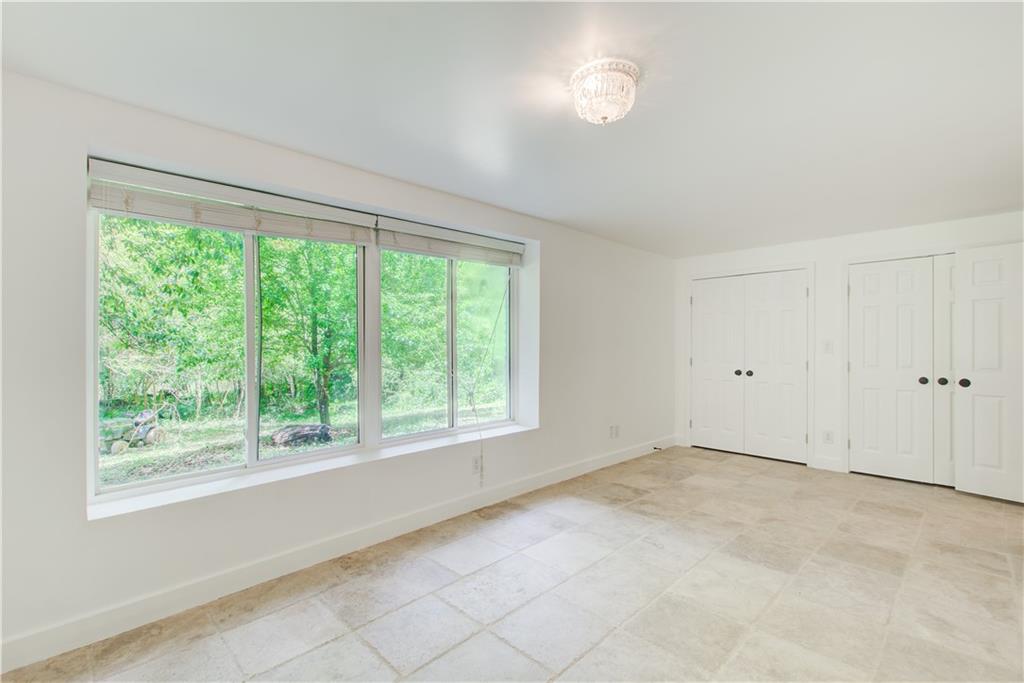 1676 Moores Mill Road Northwest Atlanta, GA 30327 - Photo 28 of 32 a view of an empty room with a window